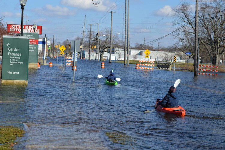 A pair of kayakers take advantage of the high waters during the 2018 flood.