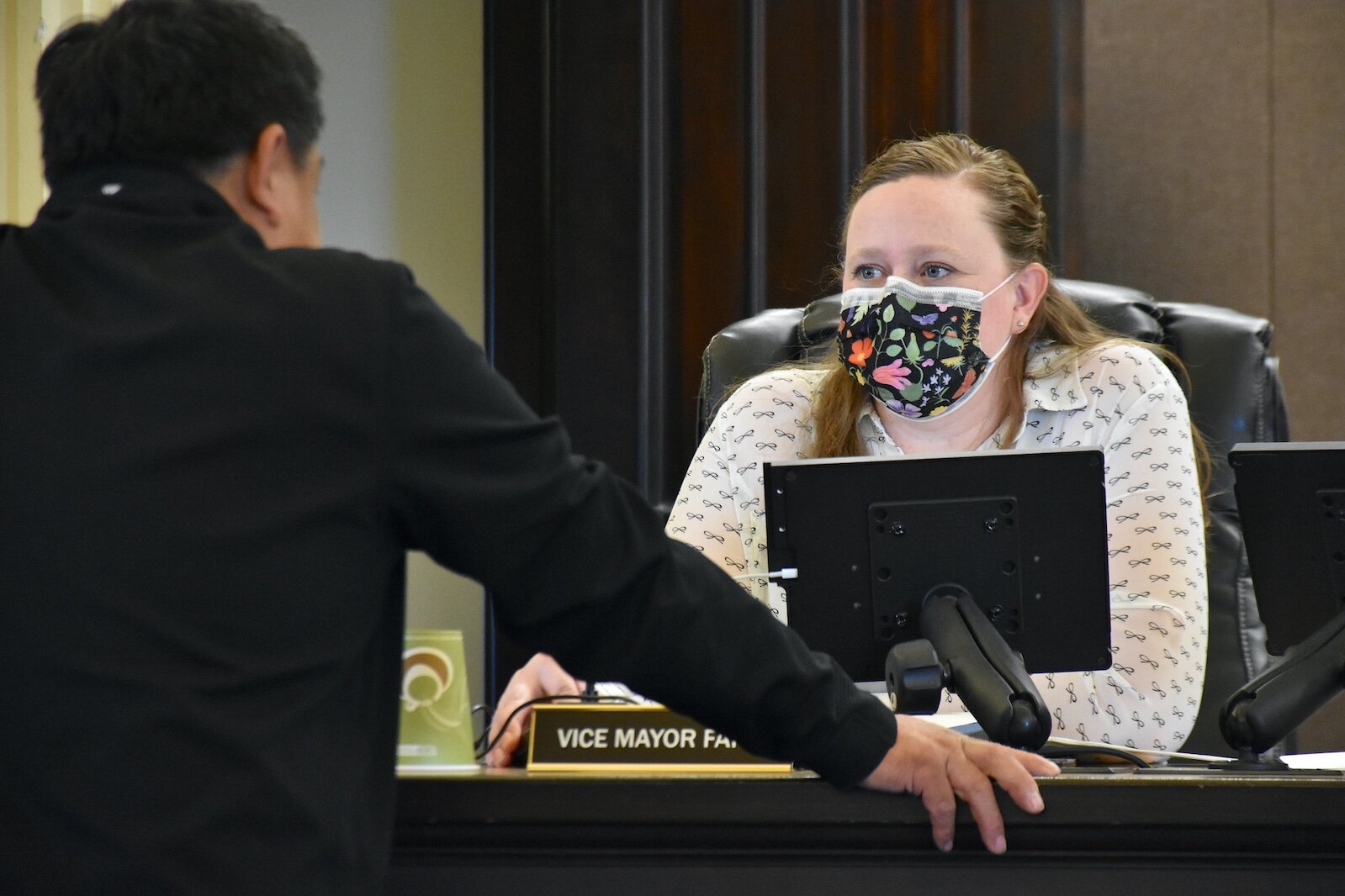 Kaytee Faris, Battle Creek City Commission and Vice Mayor, talks with fellow Commission member Jim Lance prior to a recent meeting.