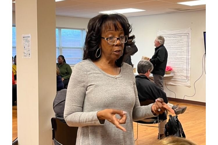 Kelly Brown, Director of Permanent Supportive Housing and Compliance   with UPholdings, talks with members of the Battle Creek delegation who traveled to Gary, Ind. 