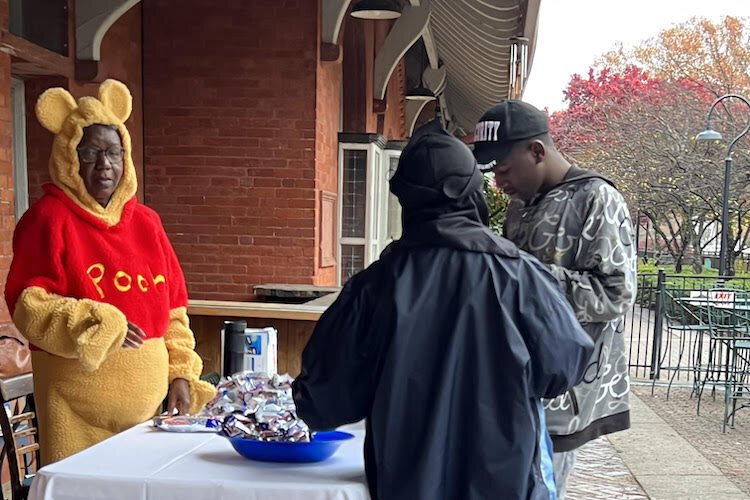 A volunteer passes out Halloween treats during KIDZ Day on Monday which kicked off a weeklong Get Out the Vote initiative sponsored by the Southwestern Michigan Urban league and the African American Collaborative.