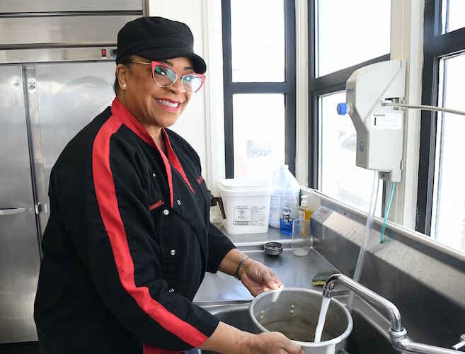 Kimberly Bennett, owner of Taste-A-Licious Catering, works out of the kitchen at Battle Creek’s First Congregational Church in Battle Creek.
