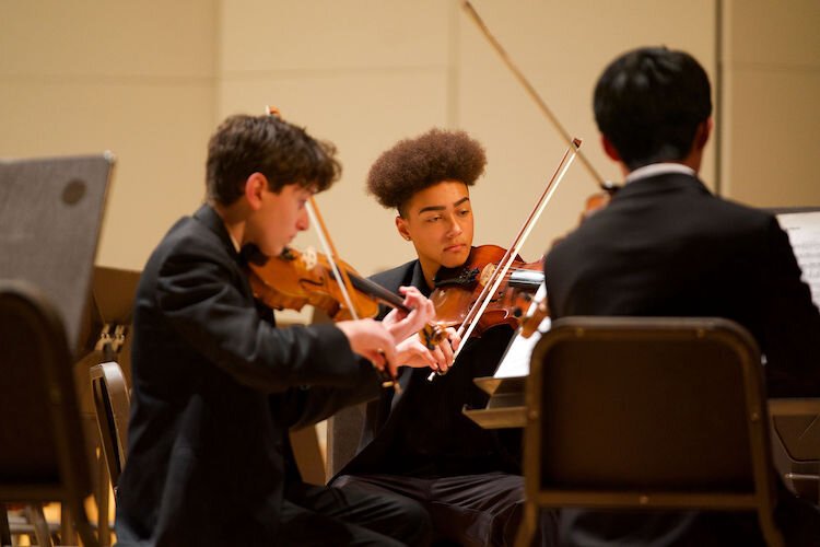 JayKwon Noble (center) performs viola in a KJSO ensemble.