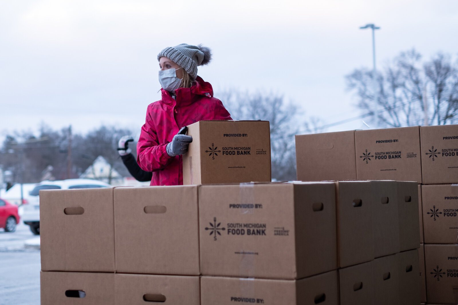 Kristine Nakashima helps distribute boxes of fresh food to those participating in the Fresh Food Pharmacy program.