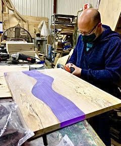 Matt Chivell, of The Designer Theory, is shown crafting a wood and epoxy surface at Kzoo Markers.