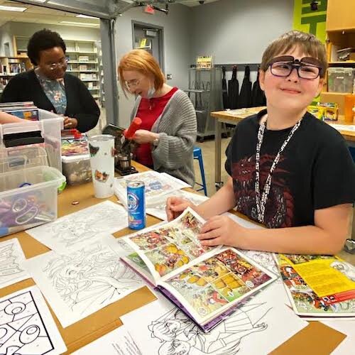 Books remain popular. About 75 percent of the circulation at the Kalamazoo Public Library is physical materials vs. 25 percent digital. A youngster is shown poring over comic books at the Central library.