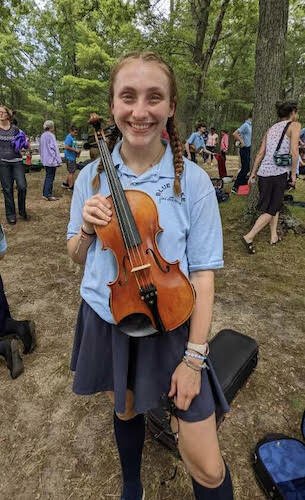  Laine Decker, a junior at Lakeview High School, poses with her violin at Blue lakes Fine Arts Camp which she has been able to attend through a BCreative scholarship.