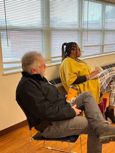 Lee Talmage, Executive Director for the Battle Creek Housing Commission, in forefront, and Boonikka Herring, Battle Creek City Commissioner, listen to a presentation about the South Shore Commons development.