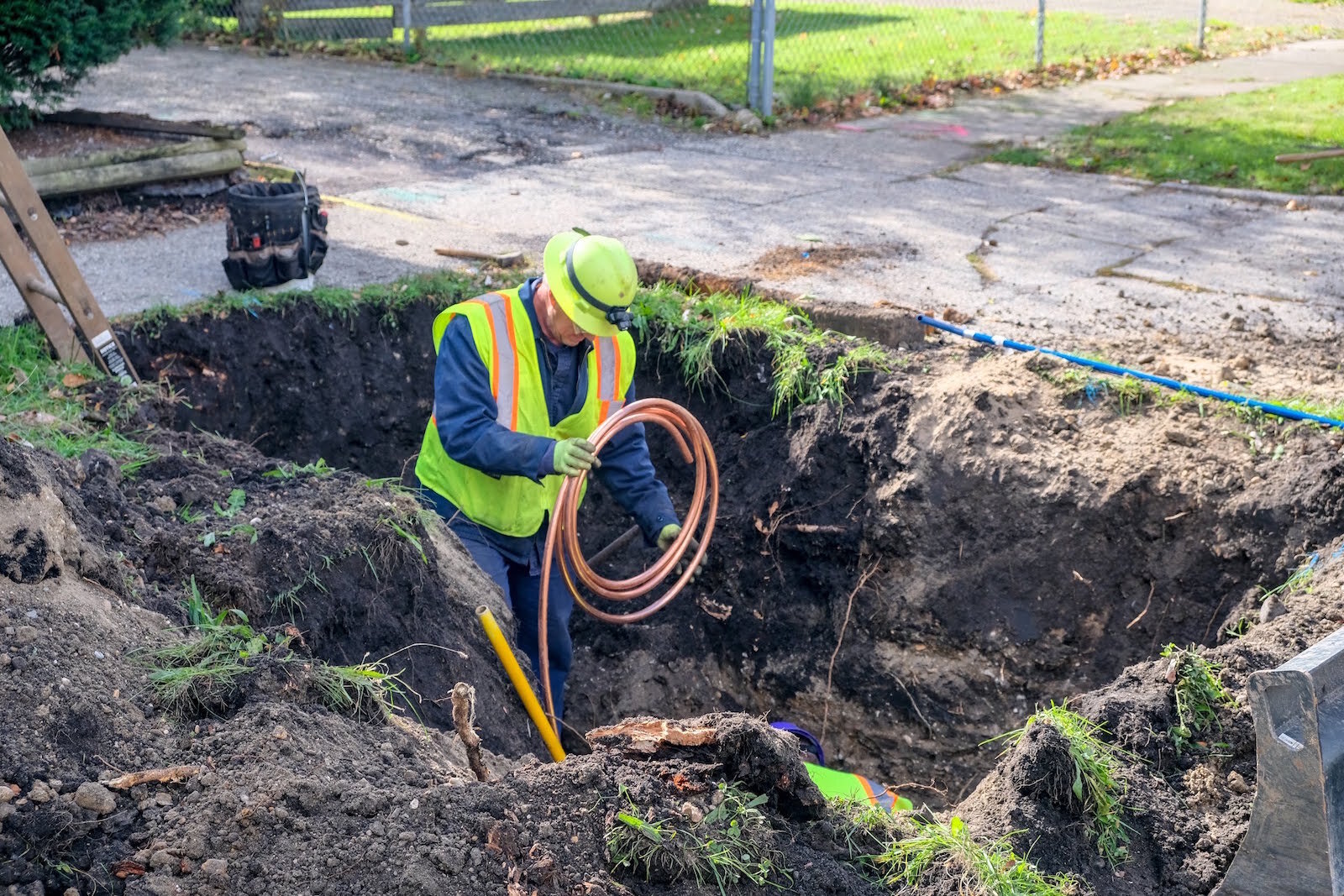 To replace lead water service lines, work crews will dig holes adjacent to houses to replace non-copper lines with copper.