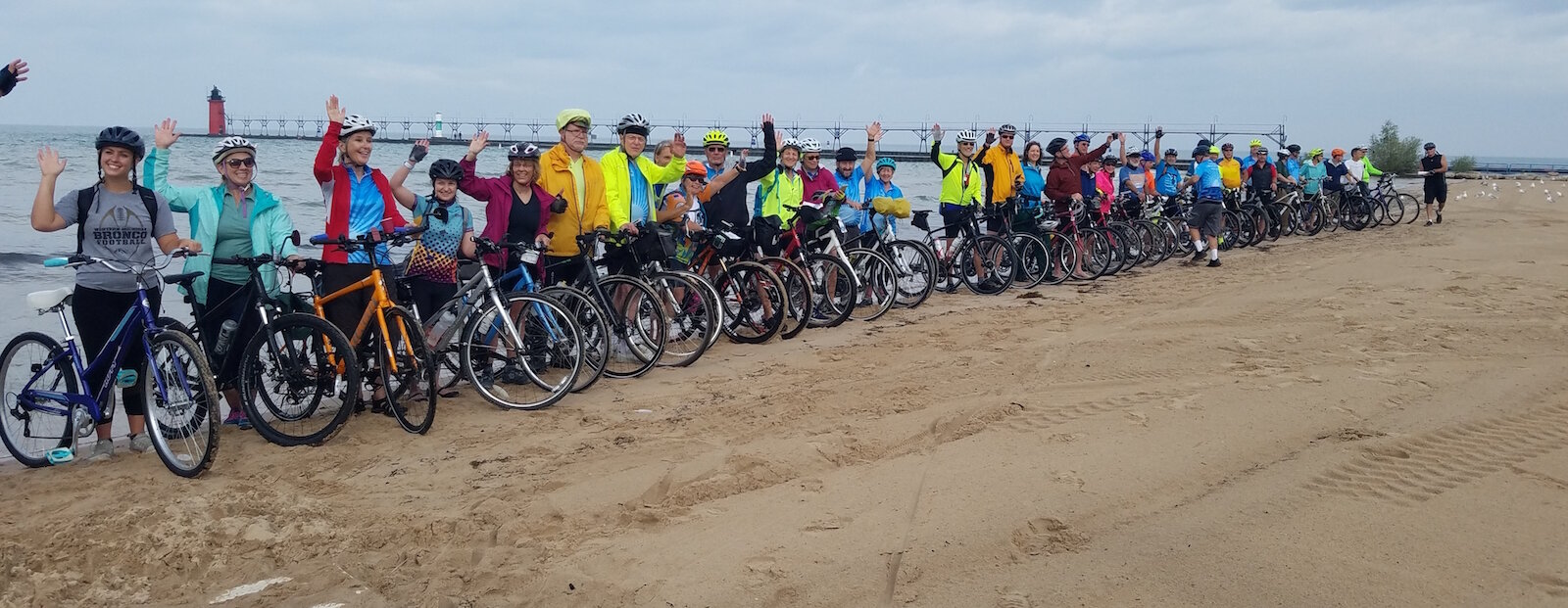 Riders dip their back tire in Lake Michigan before taking off for Lake Huron