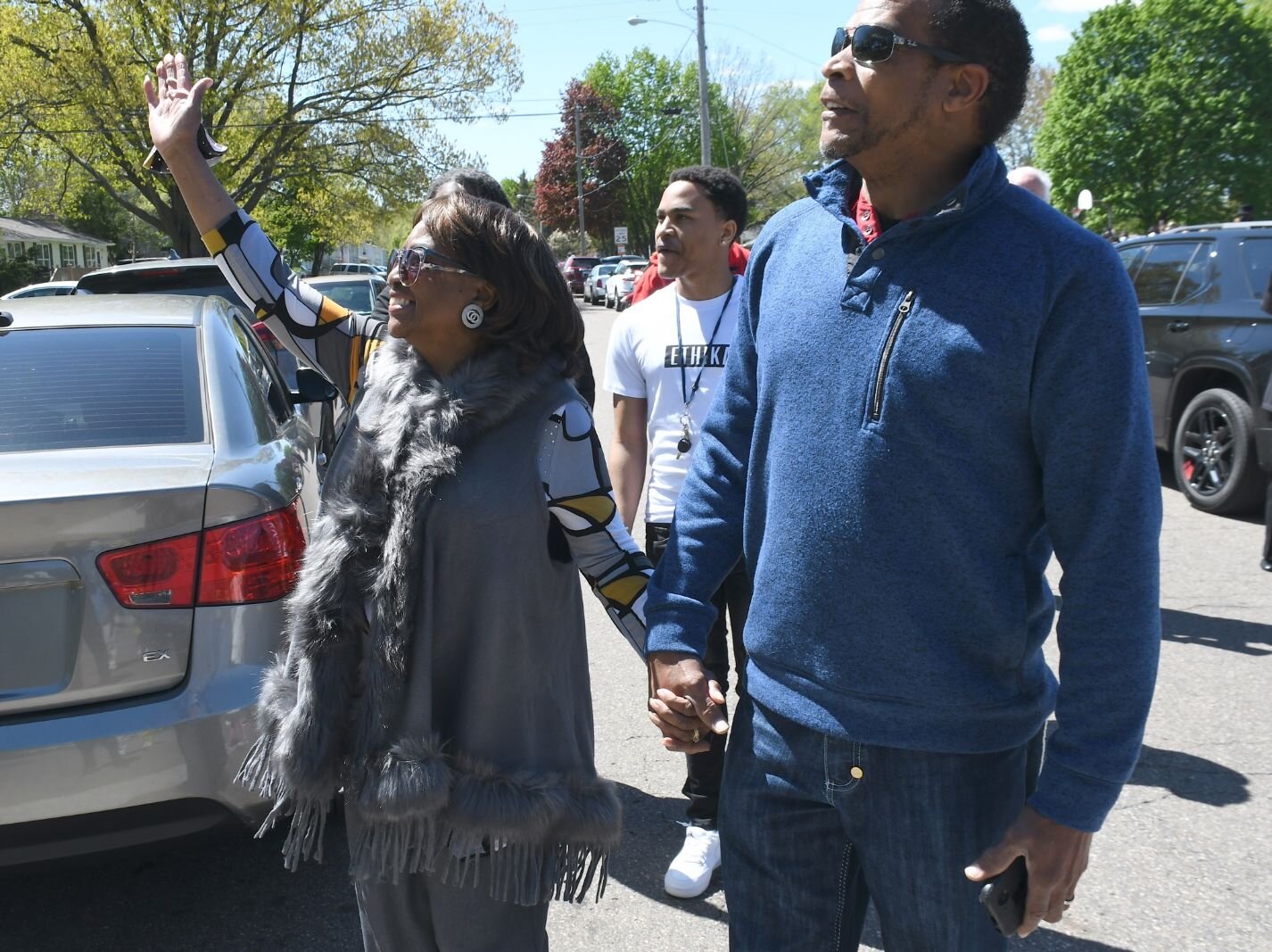 Johnny Bristol, Jr., holds hands with his mom Maude Bristol- Perry as they walk toward the street sign of Honorary Mayor Maude Bristol-Perry Avenue.