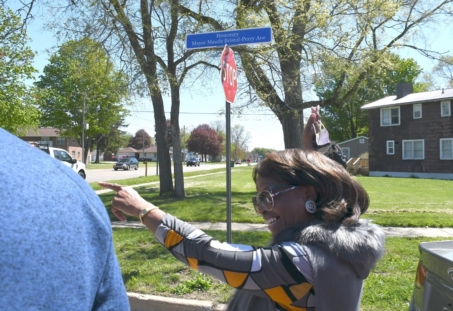 Maude Bristol-Perry reacts to the street sign of Honorary Mayor Maude Bristol-Perry Avenue.