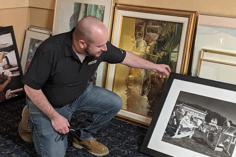 Joe Sobieralski, President and CEO of Battle Creek Unlimited, looks through old paintings and photographs that once graced the walls of the hotel.