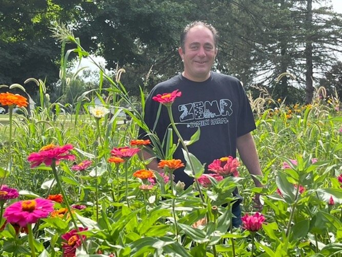 Mike Laupp poses in the flower gardens at a U-pick flower farm he and his family operate.