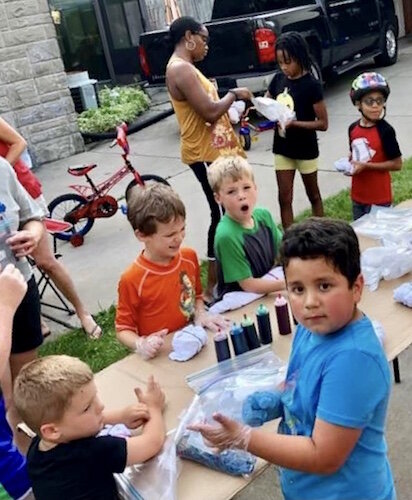 Neighborhood youngsters make tie-dyed shirts.