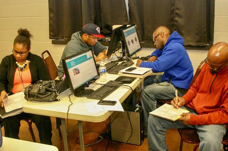 Prospective entrepreneurs are shown working on business plans during a February 2018 business class at NACD.