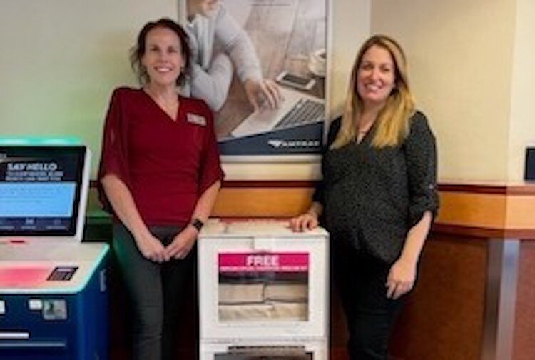 Dawn Smith (left), Executive Director of the Substance Abuse Council and Mallory Avis, City of Battle Creek Public Transit Director, stand with the new Narcan dispenser at the city's Intermodal Transportation Center in downtown Battle Creek.