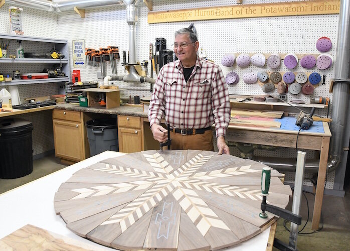 Mike Mandoka shows a table he’s working on his shop.