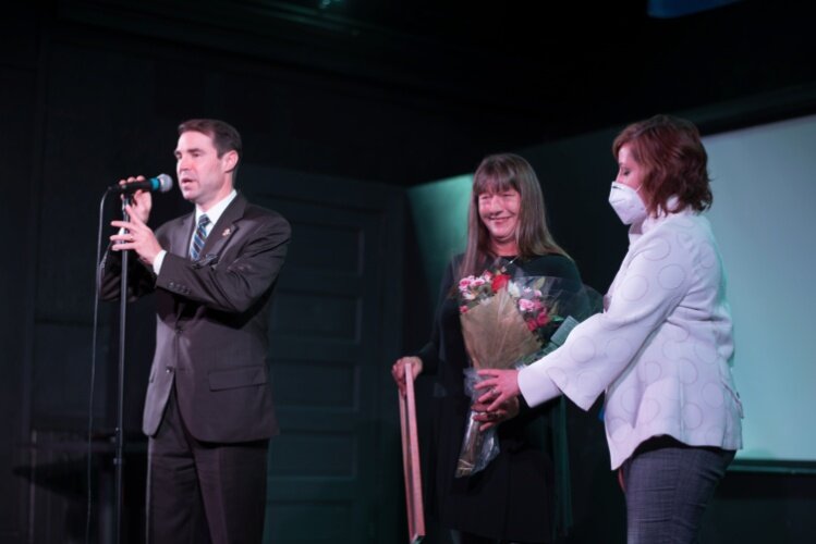 State Rep. Sean McCann and Rep. Julie Rogers presents a proclamation recognizing Tammy Taylor for her work  for her years as executive director of the Edison Neighborhood Association.