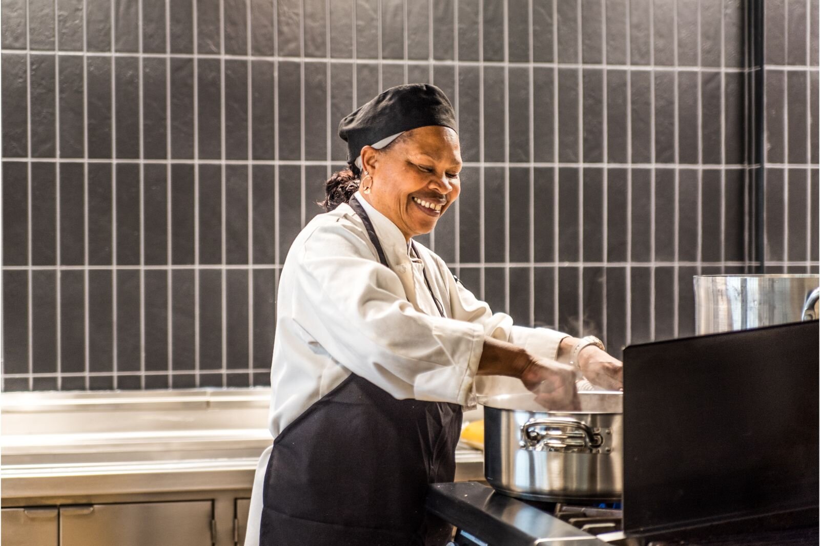 Sous Chef Lorain Langston prepares spaghetti for an evening meal in one of two indoor eateries at the new Revel Creek independent living community for older adults.