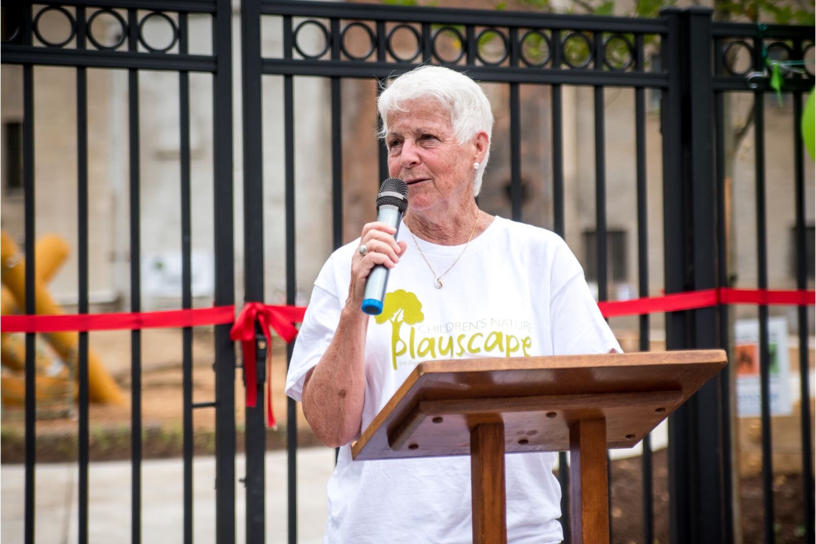 ody Brylinsky, Chair of the Kalamazoo Children’s Nature Playscape Steering Committee, offers remarks at the grand opening of Children’s Nature Playscape at Bronson Park.