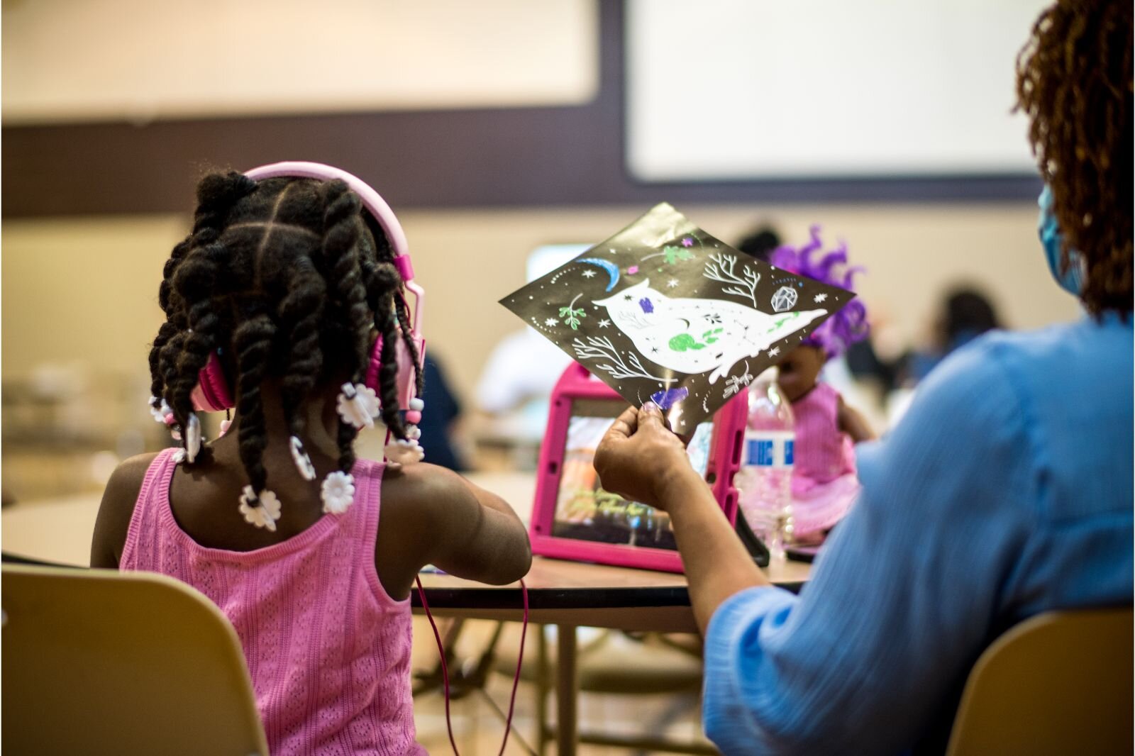 A youngster finds a way to stay entertained during a Thursday, July 21, 2022 charette, an idea-sharing community workshop.