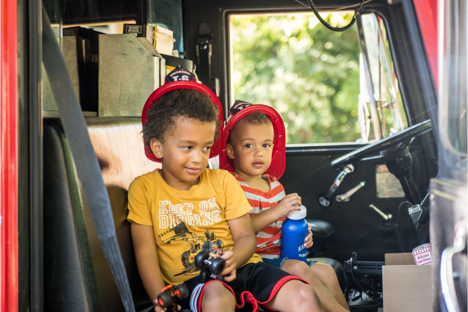 Fire trucks were on hand and youngsters put on fire hats as they sat up in the driver's seat. Photo by Fran Dwight.
