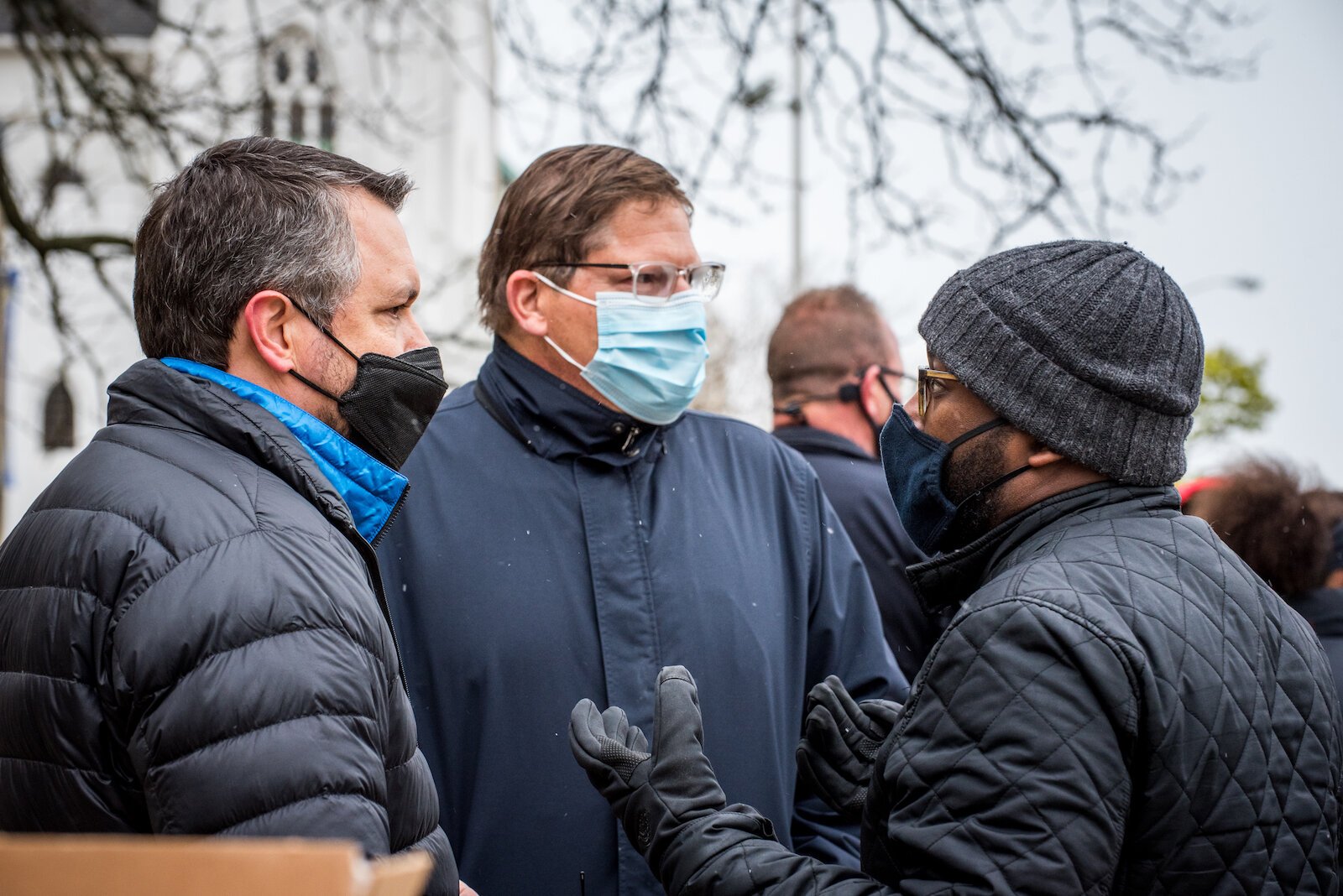 Kalamazoo City Manager Jim Ritsema, center, talks with people Tuesday outside the Kalamazoo County Courthouse. 