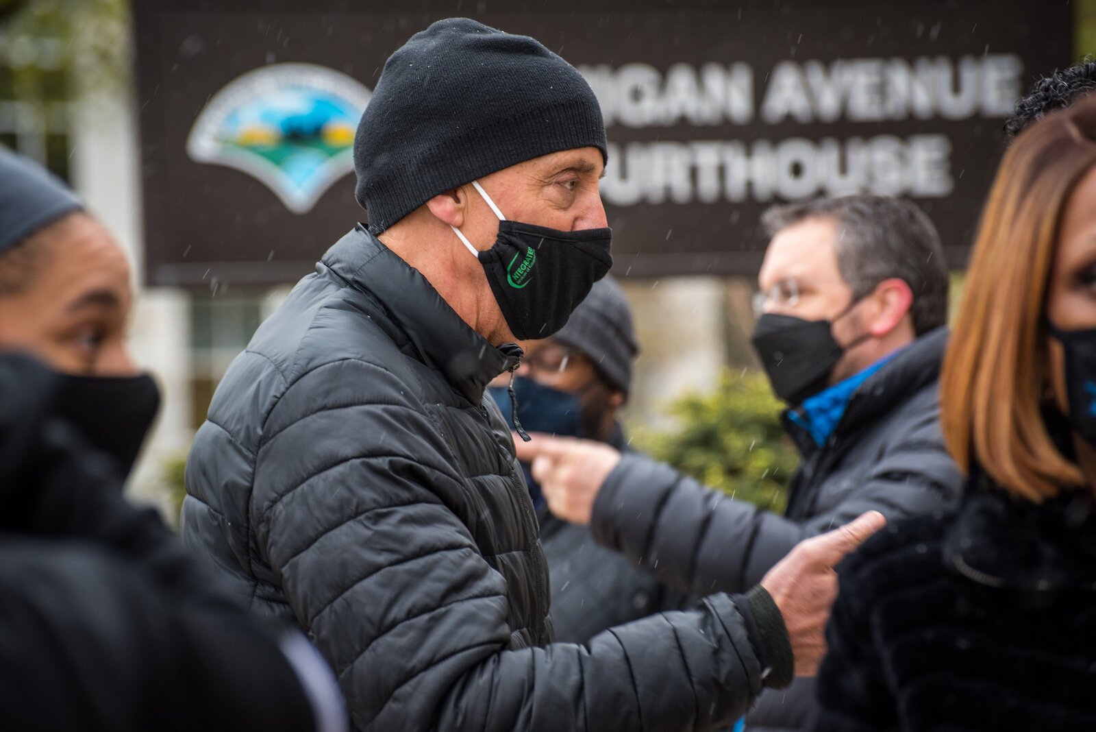 Kalamazoo Mayor David Anderson talks with people Tuesday outside the Kalamazoo County Courthouse.