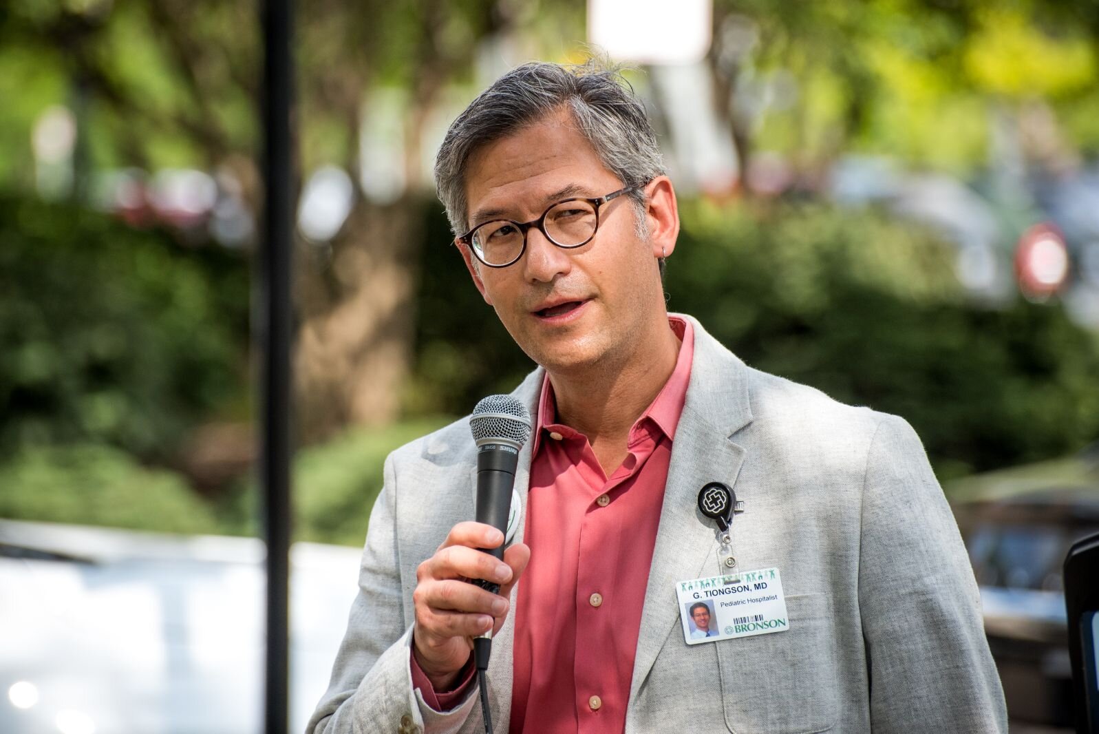 Pediatric Hospitalist Dr. Gregory Tiongson speaks at the unveiling of a sculpture honoring the work of John Polzin, a leader with the Bronson Health Foundation.