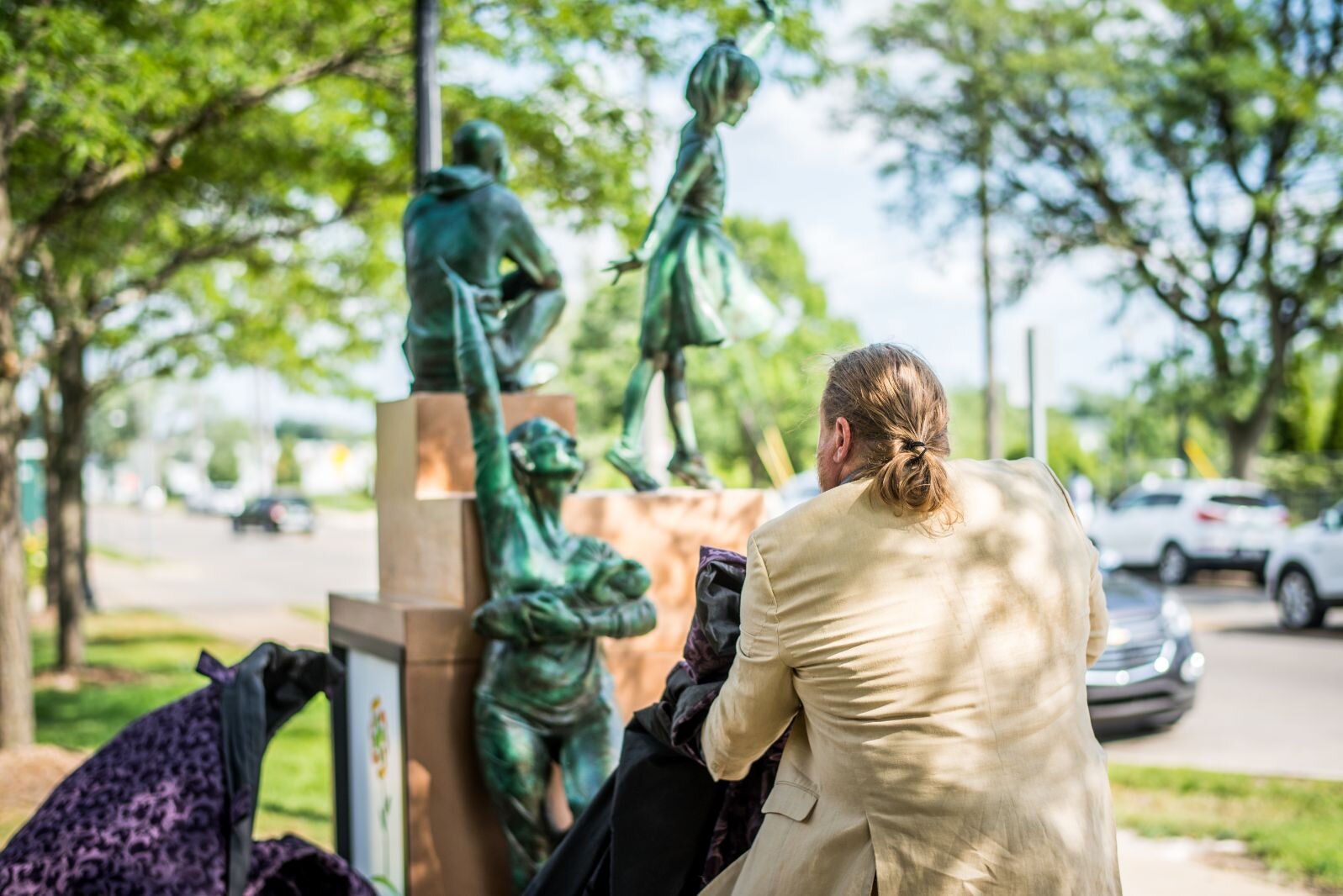 Kalamazoo sculptor Joshua Diedrich unveils the artwork he created now standing outside Bronson Methodist Children’s Hospital.