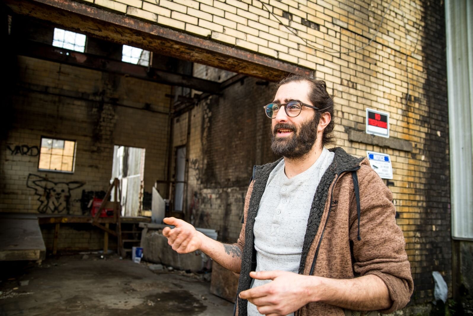 Matthew Schmidt, shown outside his building at 1809 Reed St., says he wants help to stop illegal dumping in in in a vacant lot behind the building.