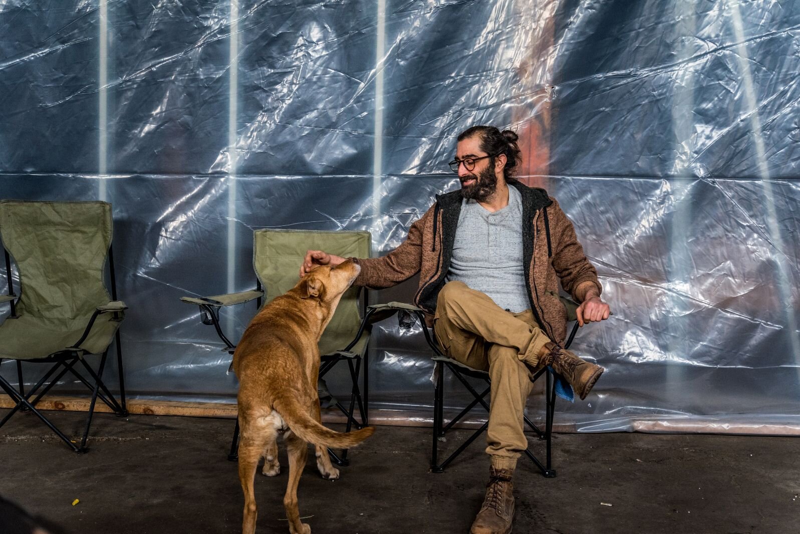 Building owner Matthew Schmidt, shown with his dog, likes an effort by the Edison Neighborhood Association to identify and put pressure on people to stop illegal dumping and cleanup problem sites.