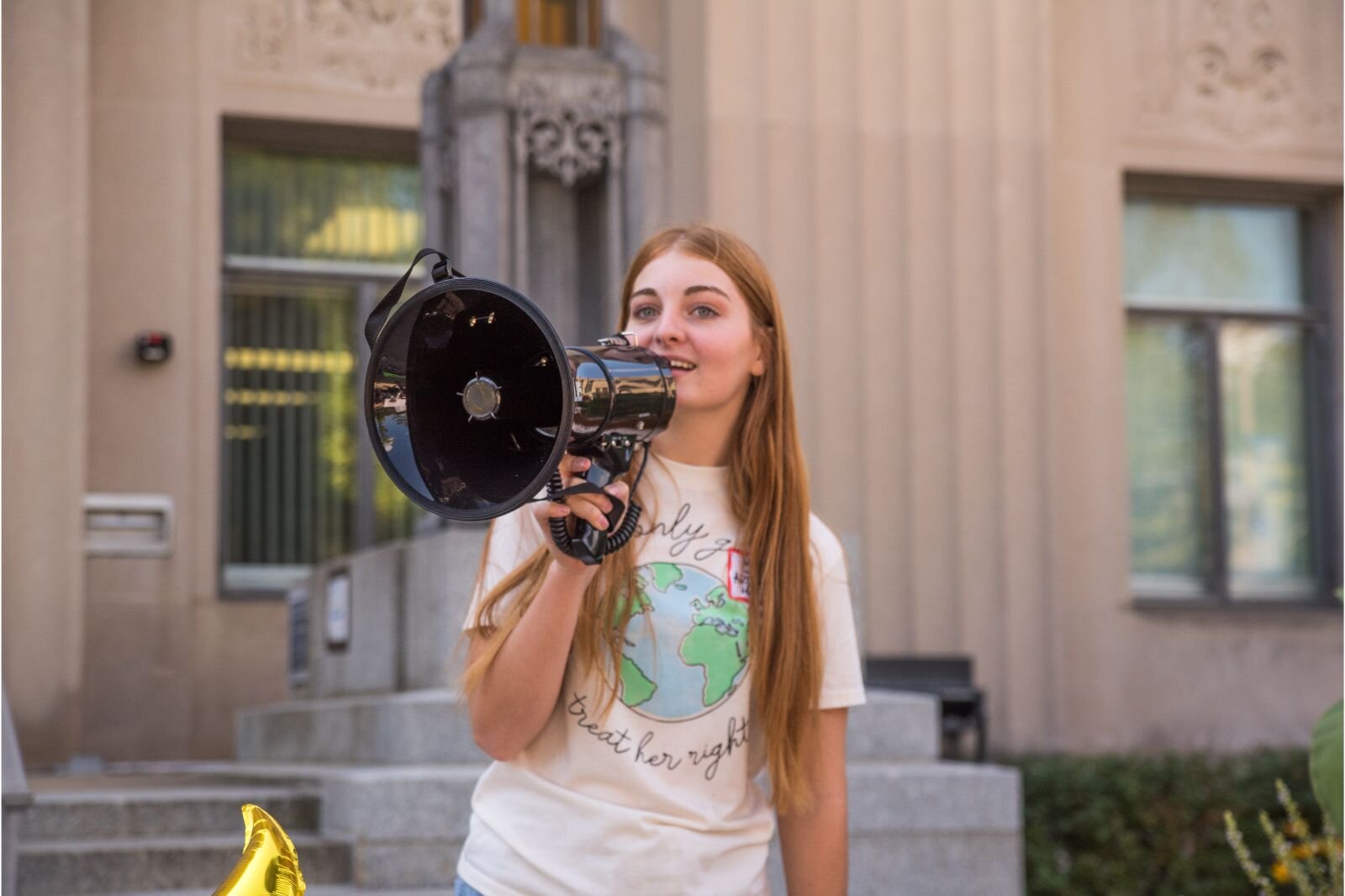 Mia Breznau, one of the Youth Climate Strike organizers, with megaphone addresses the marchers.
