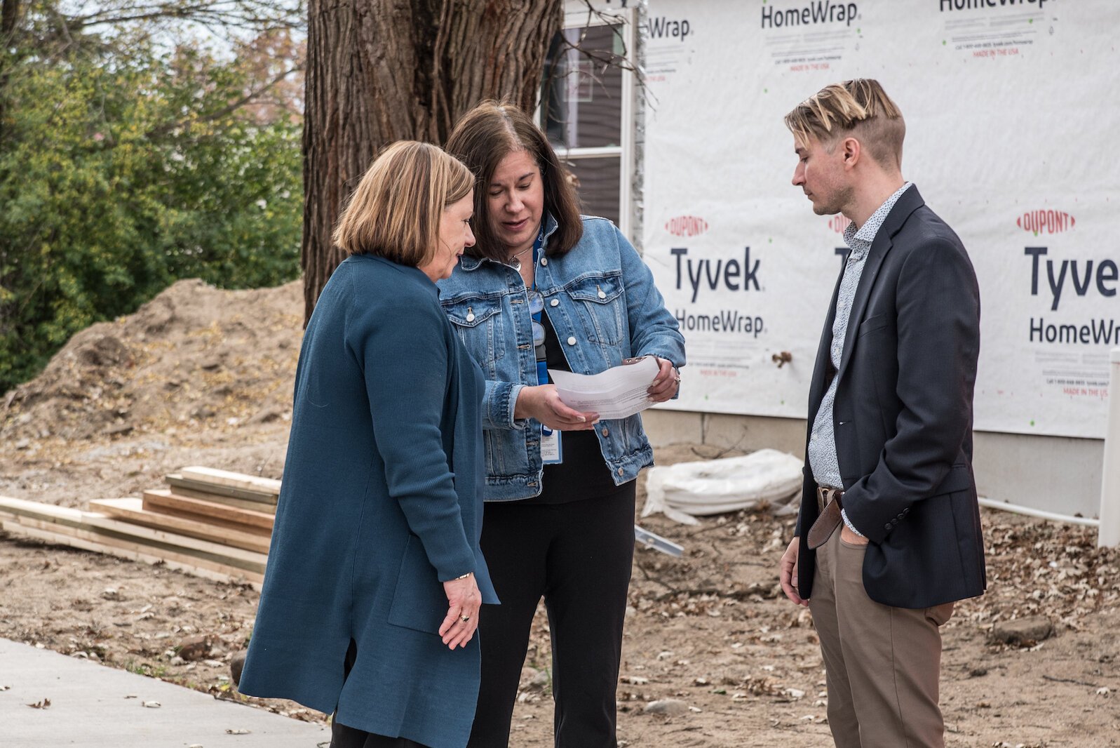 Sharilyn Parsons, housing development project coordinator for the City of Kalamazoo, center, talks with Beth McCann, acting executive director of KNHS, left, and Milcarek, director of construction services for KNHS, right.