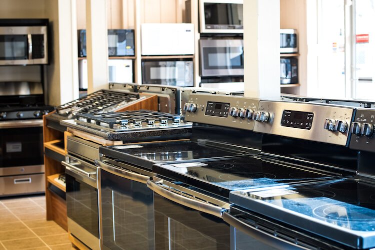 New home appliances are arranged in rows in the 7,000-square-foot showroom of George’s Appliance Co.