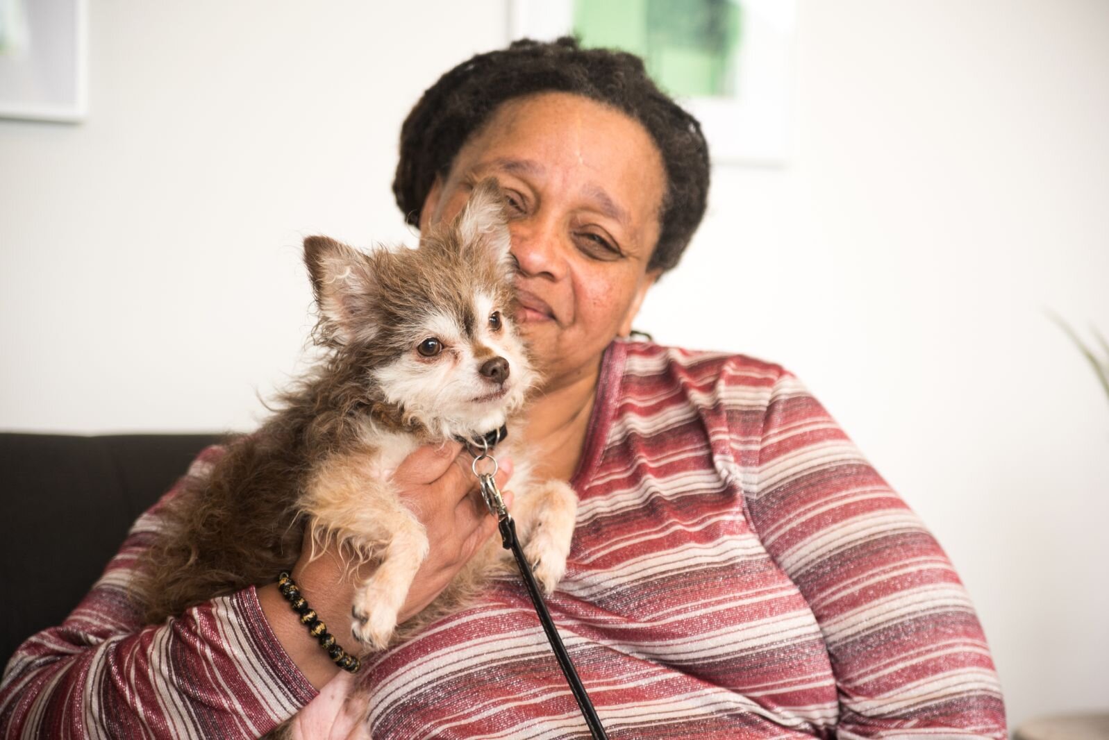 Harrison Circle Apartments resident Carmen and her dog enjoy its well-lighted lobby area.