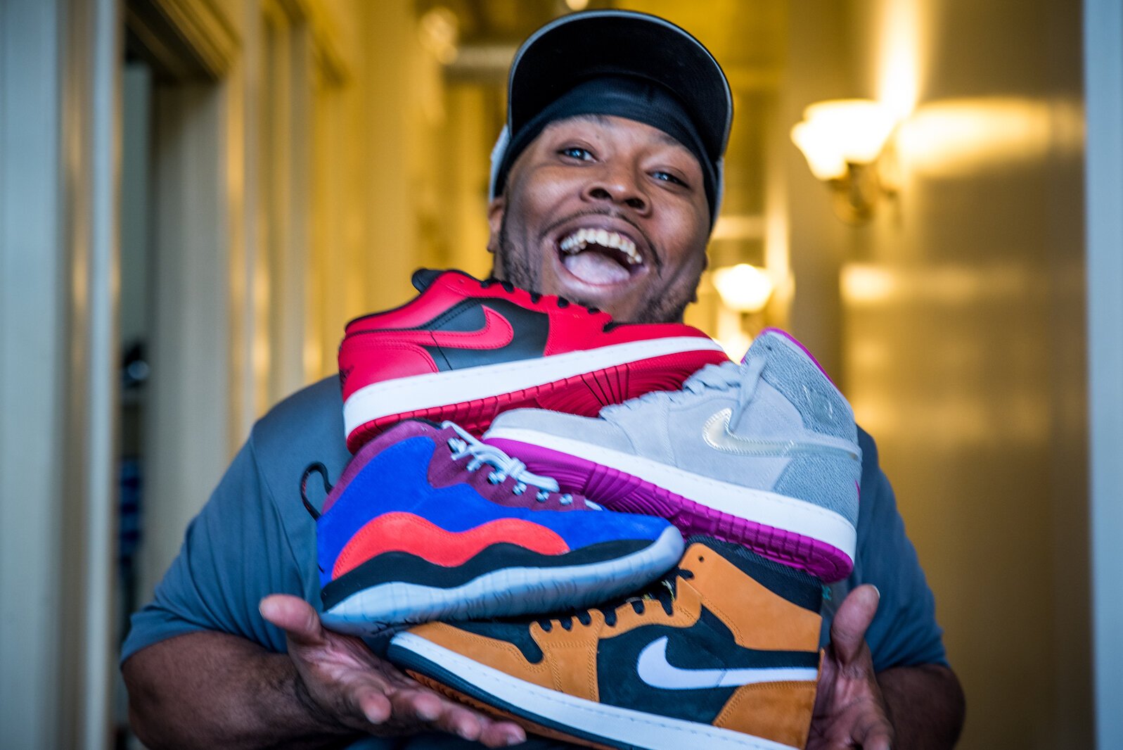 Roosevelt Lee-Fleming of Kalamazoo holds some of the sneakers that have been the focus of his business, The Drip Sneakers LLC.