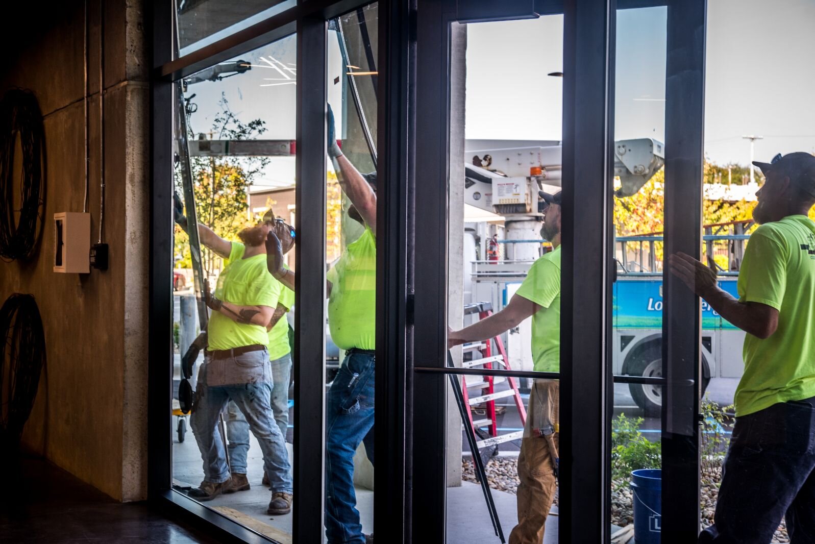 Workers continue to put the finishing touches on the residential/commercial project, Harrison Circle Apartments at 525 E. Ransom St.