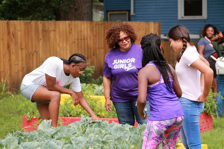 Pam Roland and a group of participants in Kalamazoo Junior Gilrs Organization camp at the garden at Paterson and Princeton