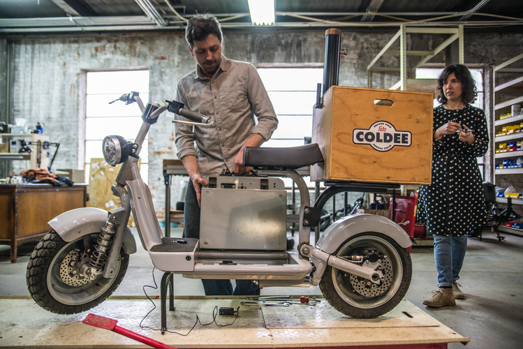 Jeb and Krystal set up a scooter to take to an event. The box delivers Nitro Coffee from a spigot.