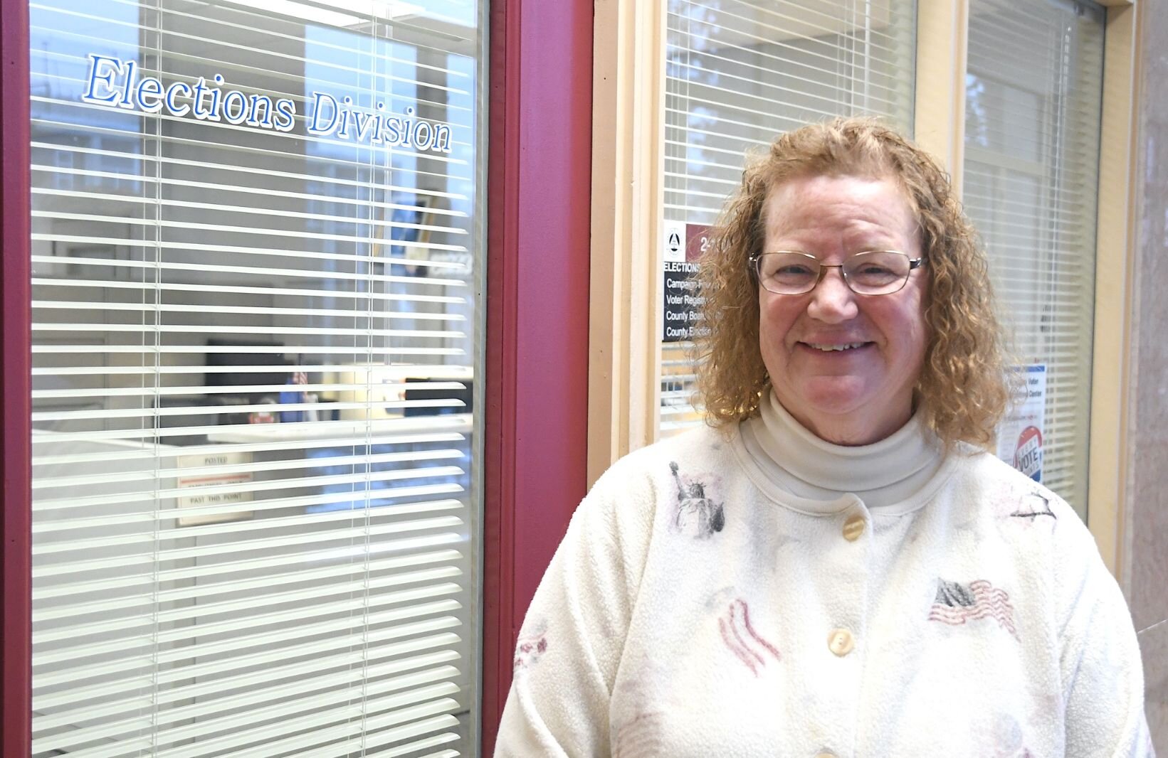 Teri Loew, Chief Deputy Clerk of Elections for Calhoun County, stands in front of her office.