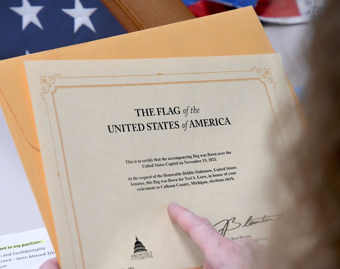 A certificate indicates an American flag that flew over the U.S. Capital in honor of Teri Loew.