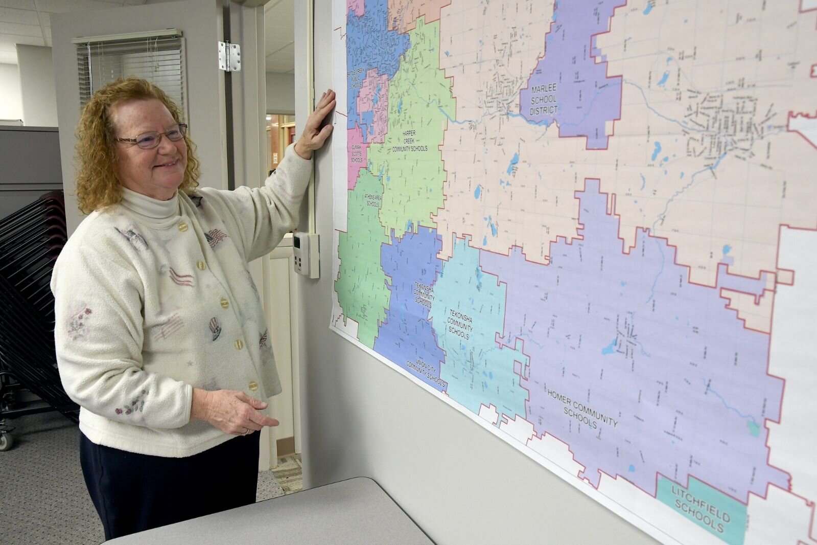 Teri Loew, Chief Deputy Clerk of Elections for Calhoun County, looks at map of Calhoun County.