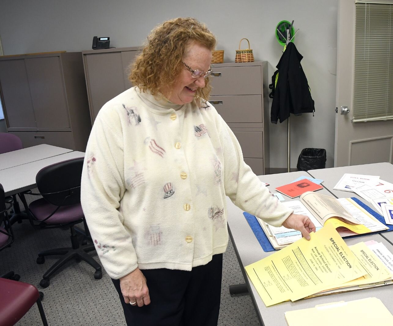 Teri Loew, Chief Deputy Clerk of Elections for Calhoun County, reviews old election materials.