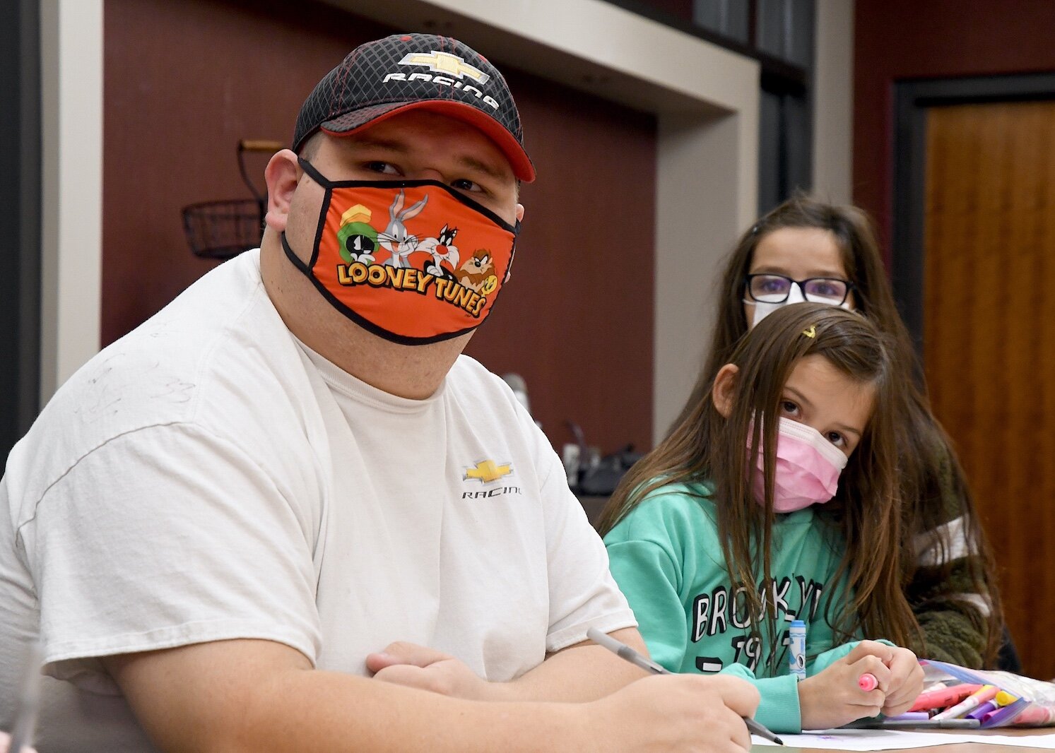 Watching a video of “The Forever Sky” by Thomas Peacock, are Tribal Youth Program members, from left, Alan Mackety, Kendall Goldner, and Brooklyn Goldner.