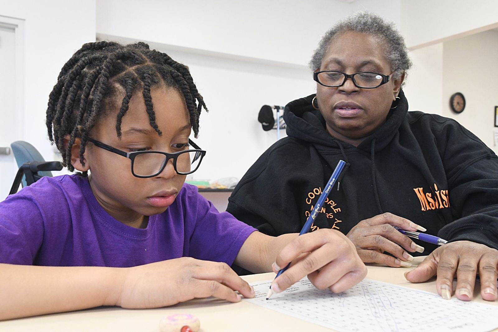 Lisa McNeil, right, works with King Matthews during a Cool People after-school session at Kingdom Builders.