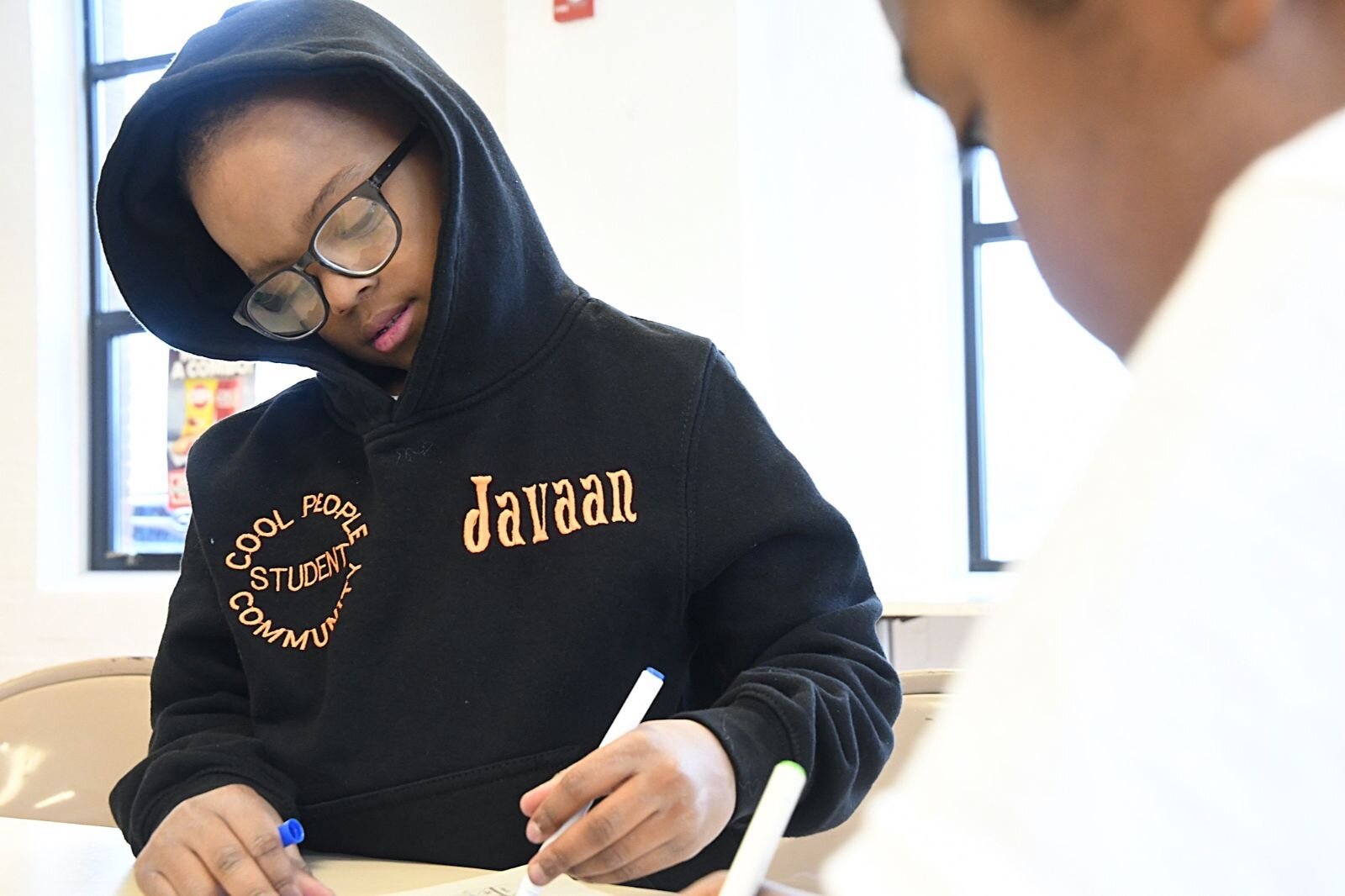 Javaan James, left, works on a project during a Cool People after- school session at Kingdom Builders.