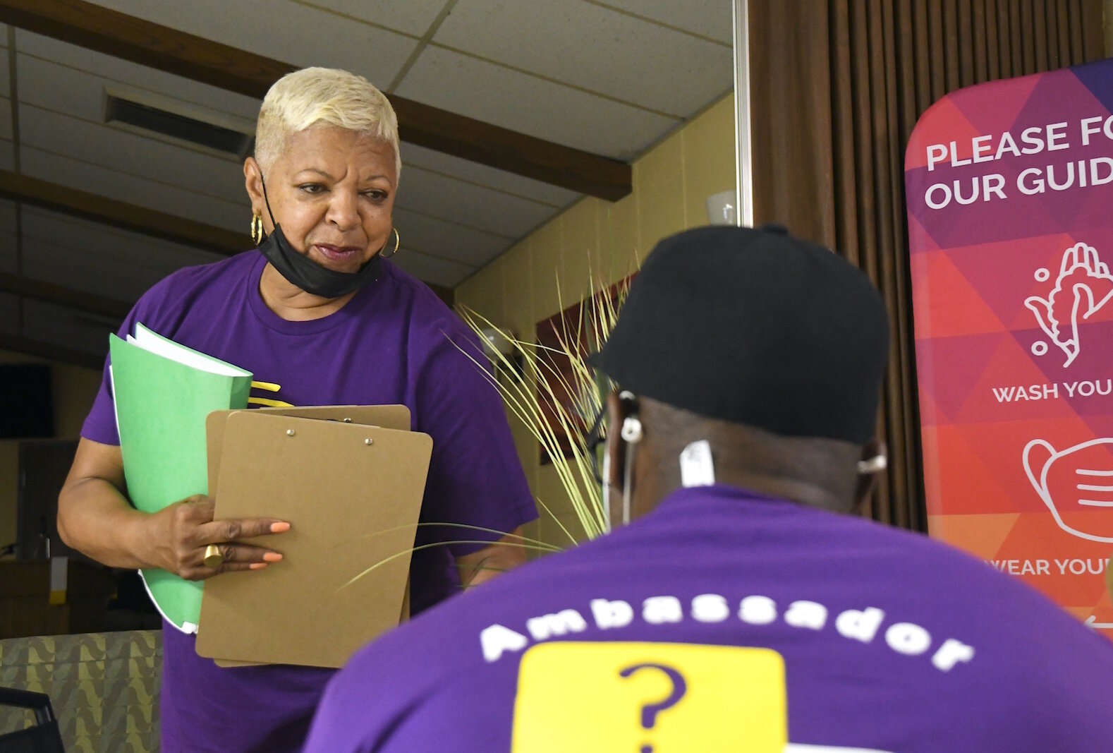 Sharon Miller hands out information to COVID Vaccine Ambassadors at Washington Heights United Methodist Church. 