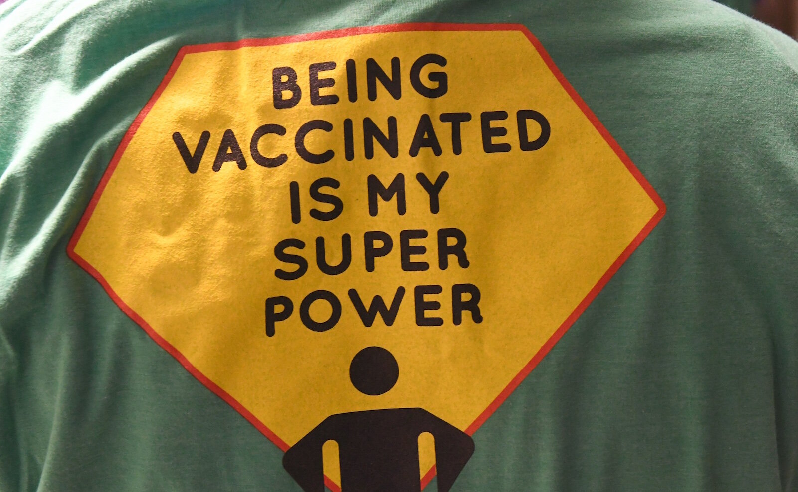 Message on the back of T-shirts worn by COVID Vaccine Ambassadors.