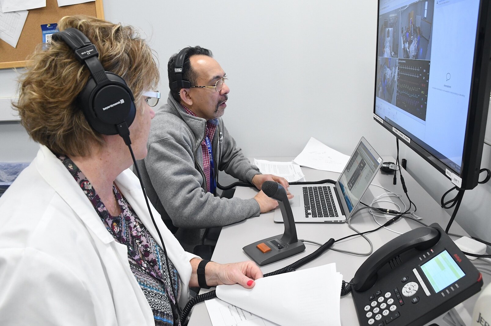 Renee Mielke, Ed.D., nursing professor, left, and Rico Earl, simulation coordinator, observe KCC nursing students treating a patient in the college’s sim lab.